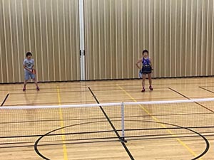 neighbors playing pickleball