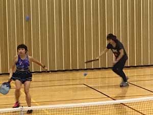 neighbors playing pickleball