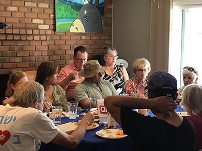 food and neighbors at potluck dinner discussion about the conflict in Israel and Gaza