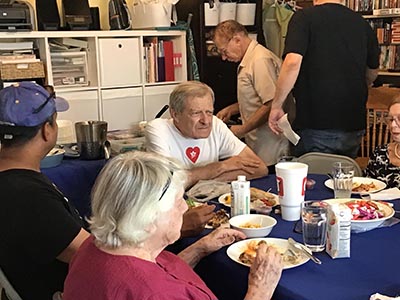 food and neighbors at potluck dinner discussion about the conflict in Israel and Gaza