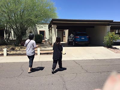 Kumiko and Kotone walking into the private home hosting the Meow-Mixer cat-lovers potluck lunch event