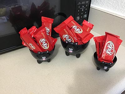 Kit Kat candy bars in cat-themed bowls at the Meow-Mixer cat-lovers potluck lunch event