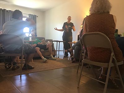 event host Diane speaking to guests at the Meow-Mixer cat-lovers potluck lunch event