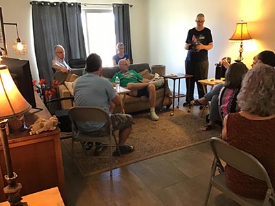 event host Diane speaking to guests at the Meow-Mixer cat-lovers potluck lunch event