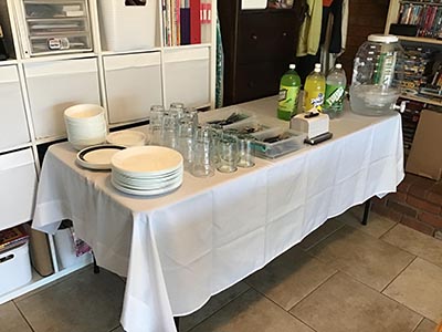 table with drinks, plates, utensils, etc.