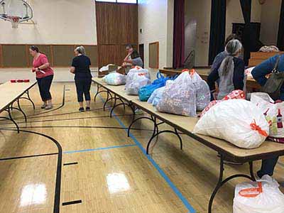 neighbors volunteering at Women4Women Tempe service project (packing party)