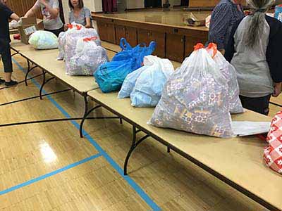 neighbors volunteering at Women4Women Tempe service project (packing party)