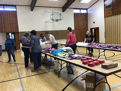 neighbors volunteering at Women4Women Tempe service project (packing party)