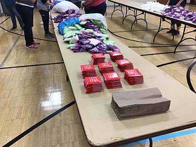 neighbors volunteering at Women4Women Tempe service project (packing party)