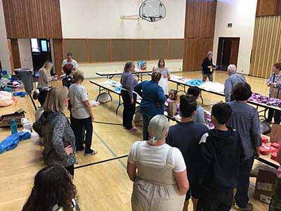 neighbors volunteering at Women4Women Tempe service project (packing party)