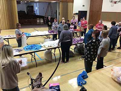 neighbors volunteering at Women4Women Tempe service project (packing party)