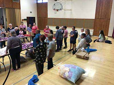 neighbors volunteering at Women4Women Tempe service project (packing party)