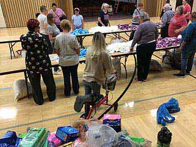 neighbors volunteering at Women4Women Tempe service project (packing party)