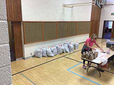 neighbors volunteering at Women4Women Tempe service project (packing party)