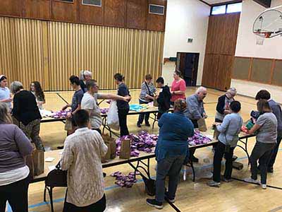 neighbors volunteering at Women4Women Tempe service project (packing party)