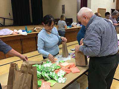 neighbors volunteering at Women4Women Tempe service project (packing party)