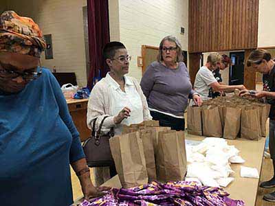 neighbors volunteering at Women4Women Tempe service project (packing party)