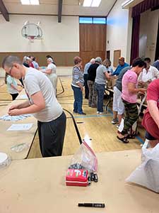 neighbors volunteering at Women4Women Tempe service project (packing party)