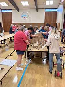 neighbors volunteering at Women4Women Tempe service project (packing party)