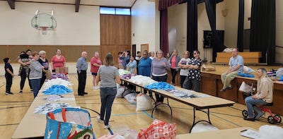 neighbors volunteering at Women4Women Tempe service project (packing party)