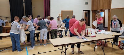 neighbors volunteering at Women4Women Tempe service project (packing party)