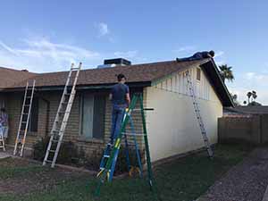 neighbors gather to scrape and paint trim on home of elderly neighbor Nellice Reidhead