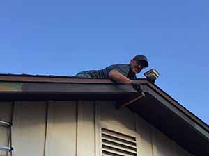 neighbors gather to scrape and paint trim on home of elderly neighbor Nellice Reidhead
