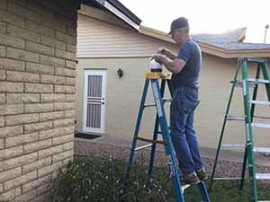 neighbors gather to scrape and paint trim on home of elderly neighbor Nellice Reidhead