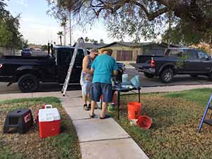 neighbors gather to scrape and paint trim on home of elderly neighbor Nellice Reidhead