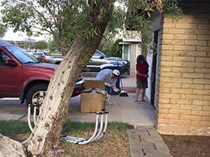 neighbors gather to scrape and paint trim on home of elderly neighbor Nellice Reidhead