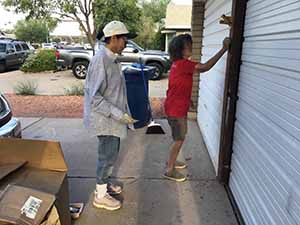 neighbors gather to scrape and paint trim on home of elderly neighbor Nellice Reidhead
