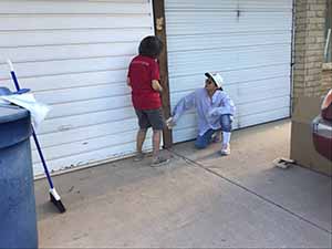 neighbors gather to scrape and paint trim on home of elderly neighbor Nellice Reidhead