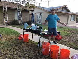 neighbors gather to scrape and paint trim on home of elderly neighbor Nellice Reidhead