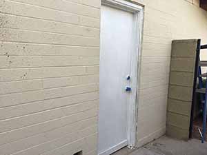 neighbors gather to scrape and paint trim on home of elderly neighbor Nellice Reidhead