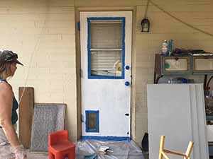 neighbors gather to scrape and paint trim on home of elderly neighbor Nellice Reidhead