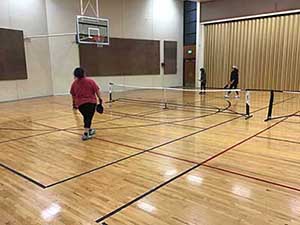 neighbors playing pickleball