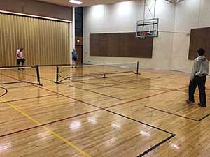 neighbors playing pickleball