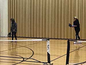 neighbors playing pickleball