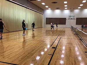 neighbors playing pickleball