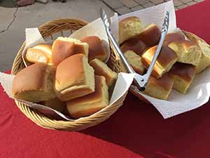 neighbors gather at for Thanksgiving Day potluck dinner