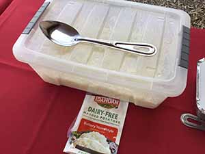 neighbors gather at for Thanksgiving Day potluck dinner