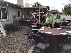 neighbors gather at for Thanksgiving Day potluck dinner