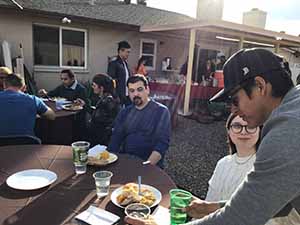 neighbors gather at for Thanksgiving Day potluck dinner
