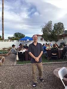 neighbors gather at for Thanksgiving Day potluck dinner