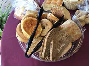 neighbors gather at for Thanksgiving Day potluck dinner