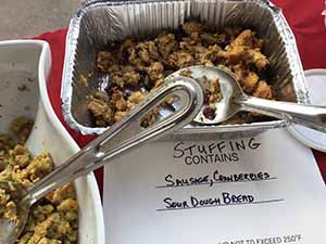 neighbors gather at for Thanksgiving Day potluck dinner