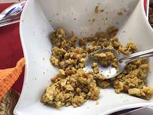 neighbors gather at for Thanksgiving Day potluck dinner