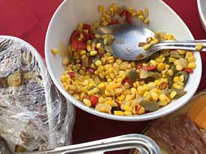 neighbors gather at for Thanksgiving Day potluck dinner