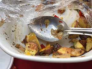 neighbors gather at for Thanksgiving Day potluck dinner