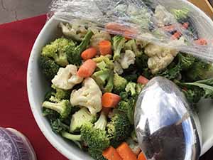 neighbors gather at for Thanksgiving Day potluck dinner